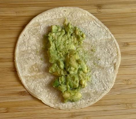 mashed avocado on the tortilla