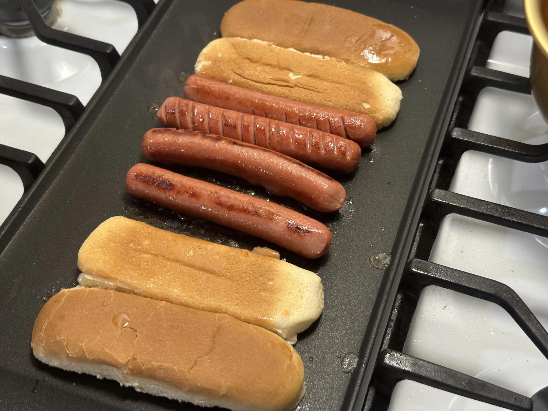 buns and sausages on the grill