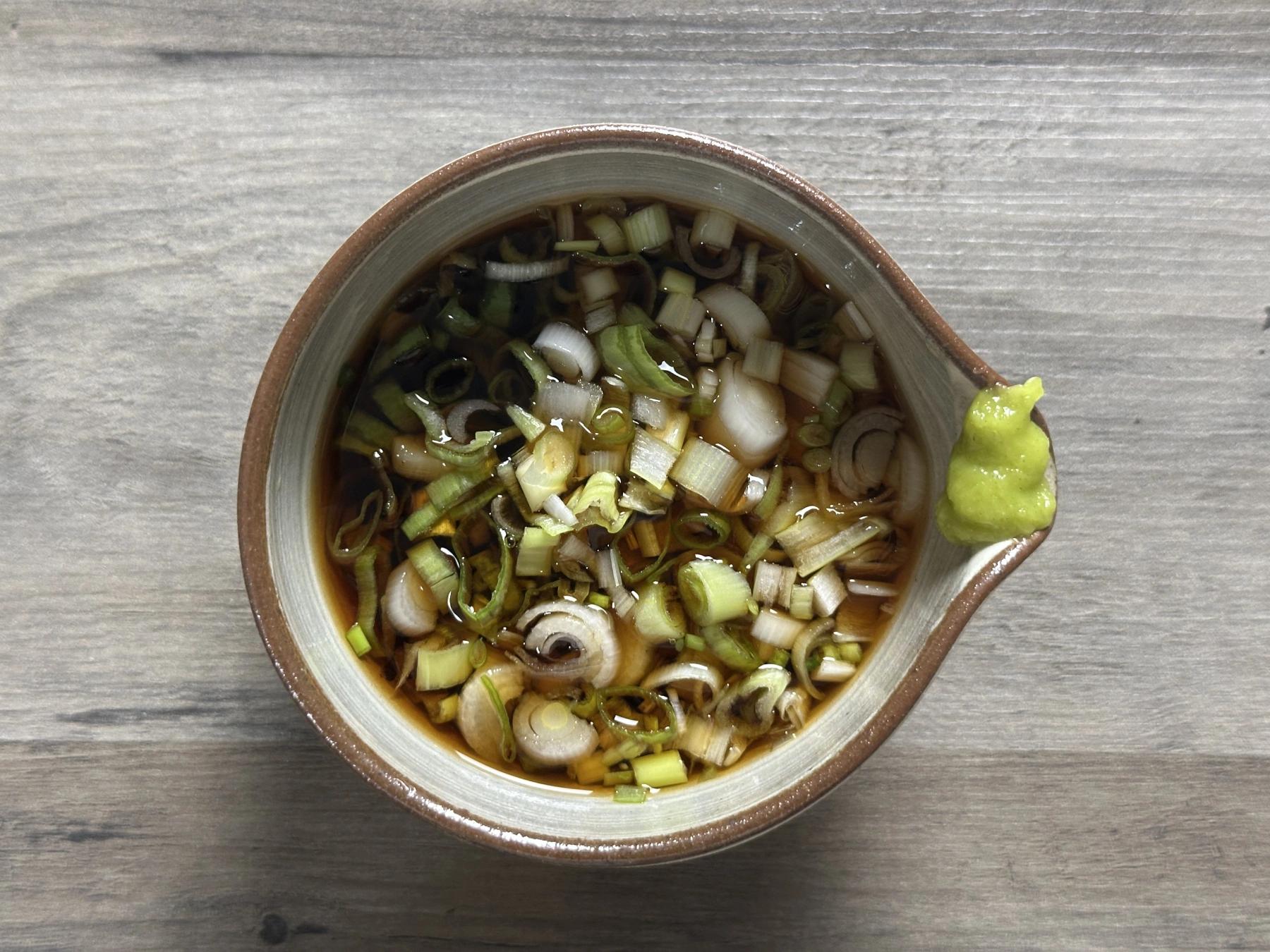tsuyu sauce with chopped green onion and wasabi