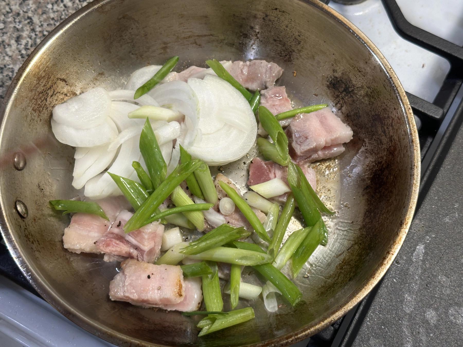 stir fry green onion and onioin with pork belly