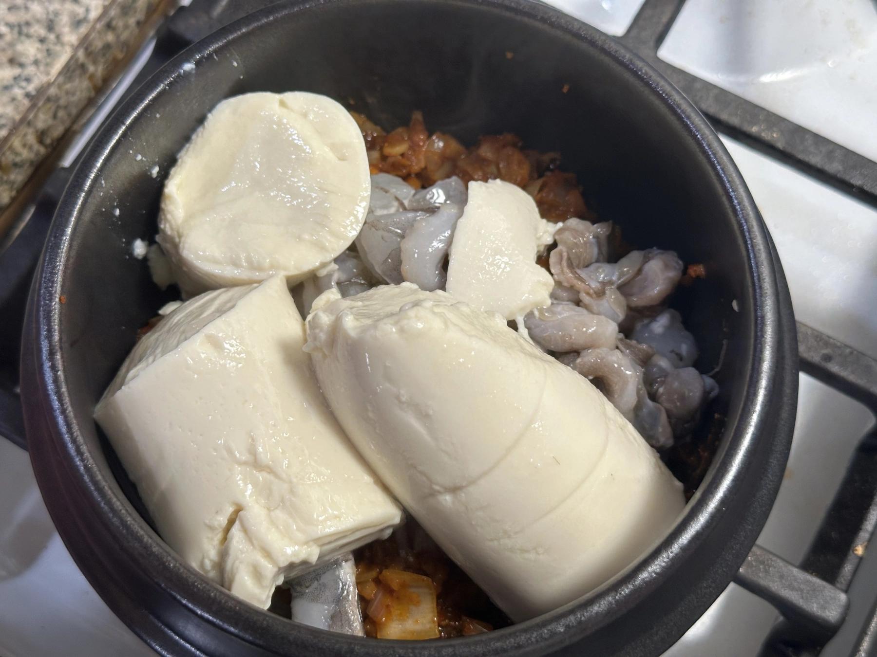 soft tofu added to the pot