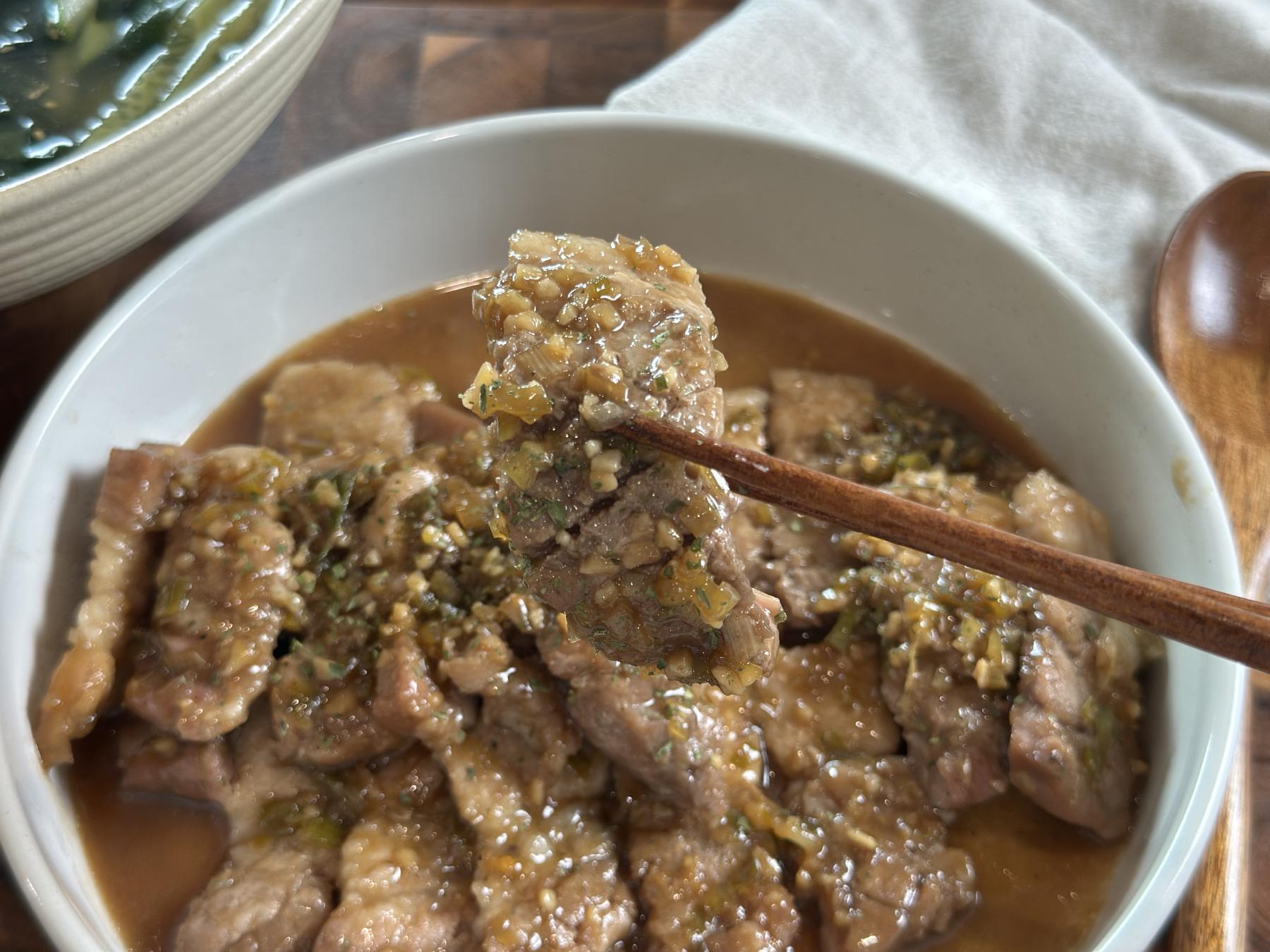 holding pork belly with chopsticks