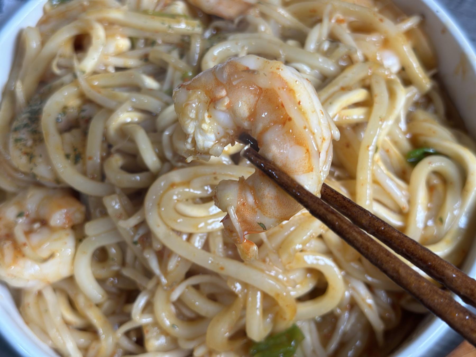 holding shrimp with chopsticks
