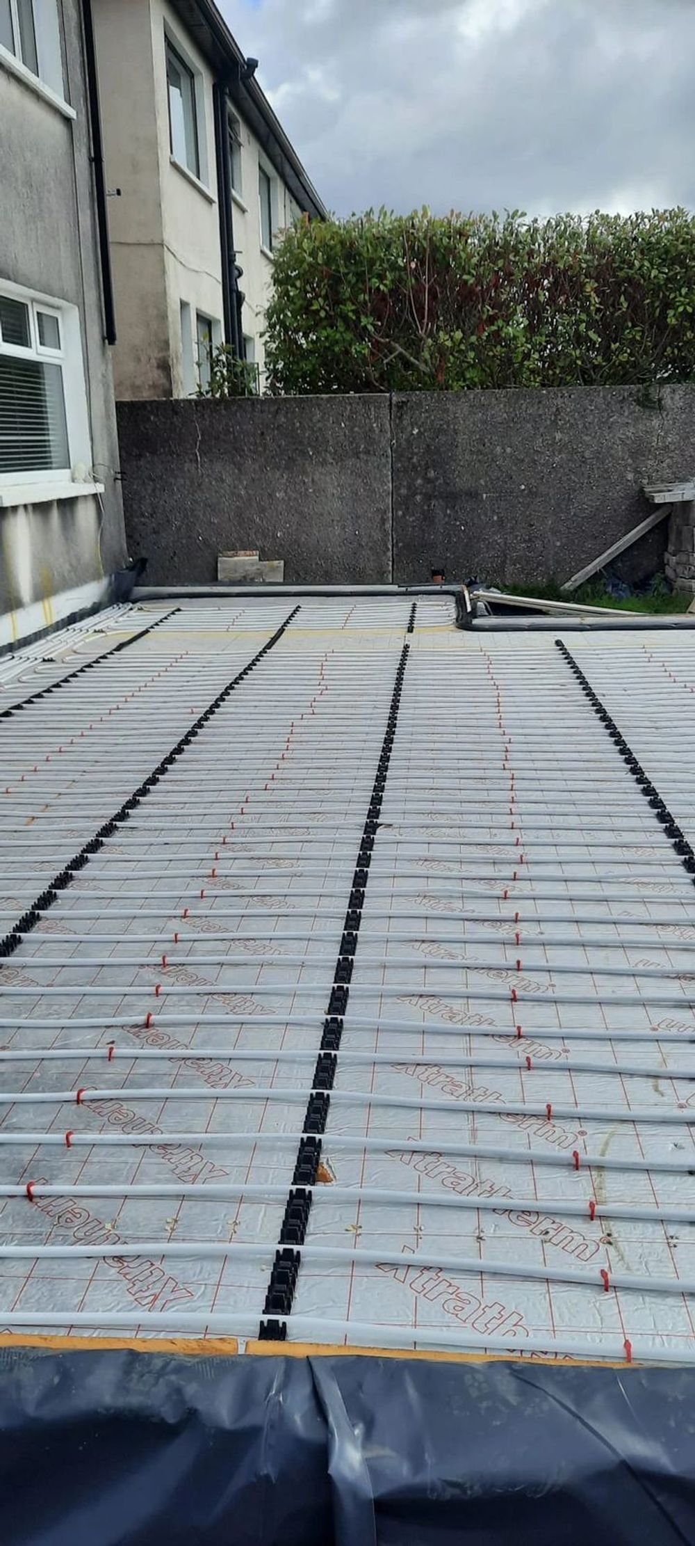 Underfloor heating laid across an outdoor extension slab