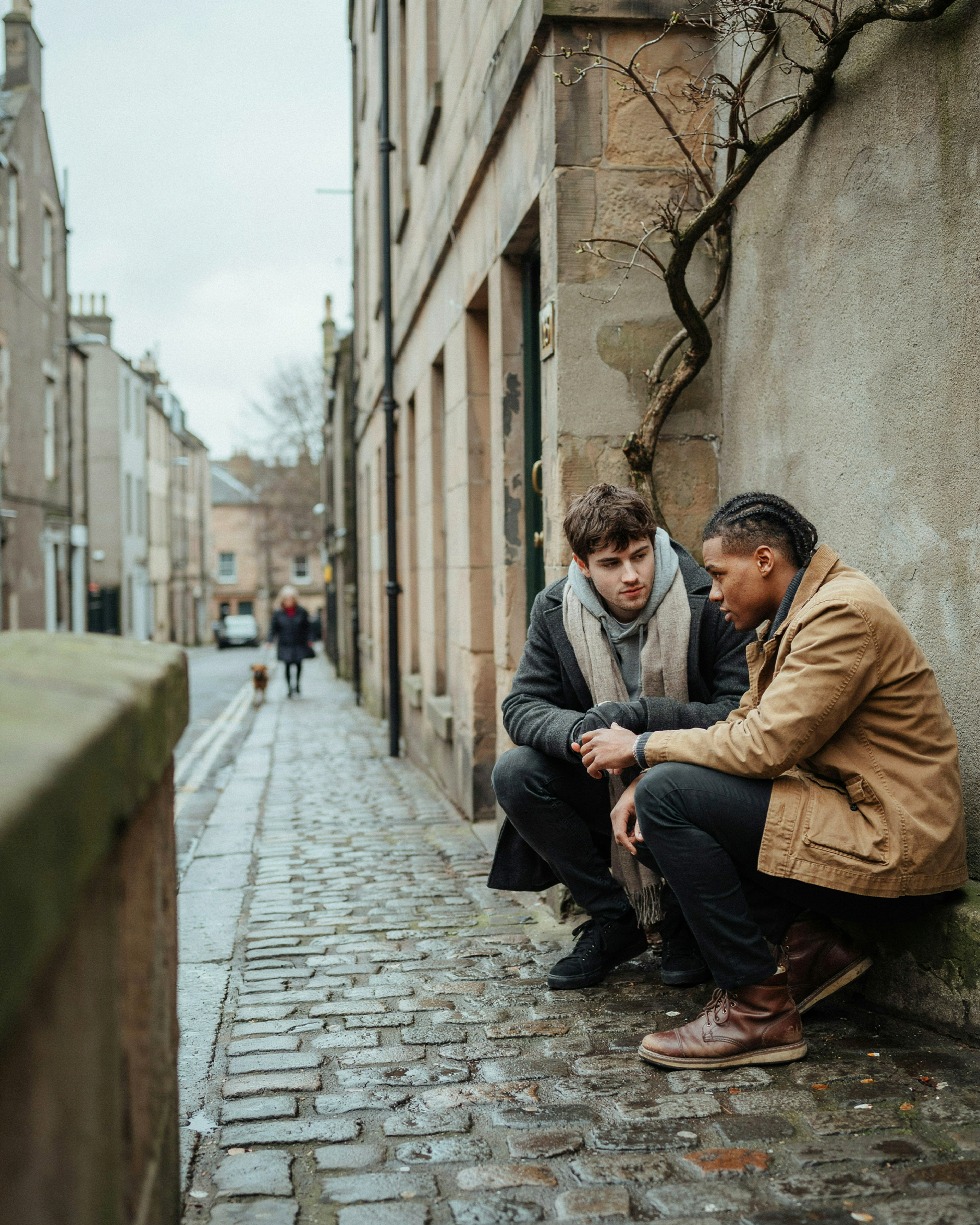 Student checking on his flatmate on the steps of a Marchmont tenement in Edinburgh