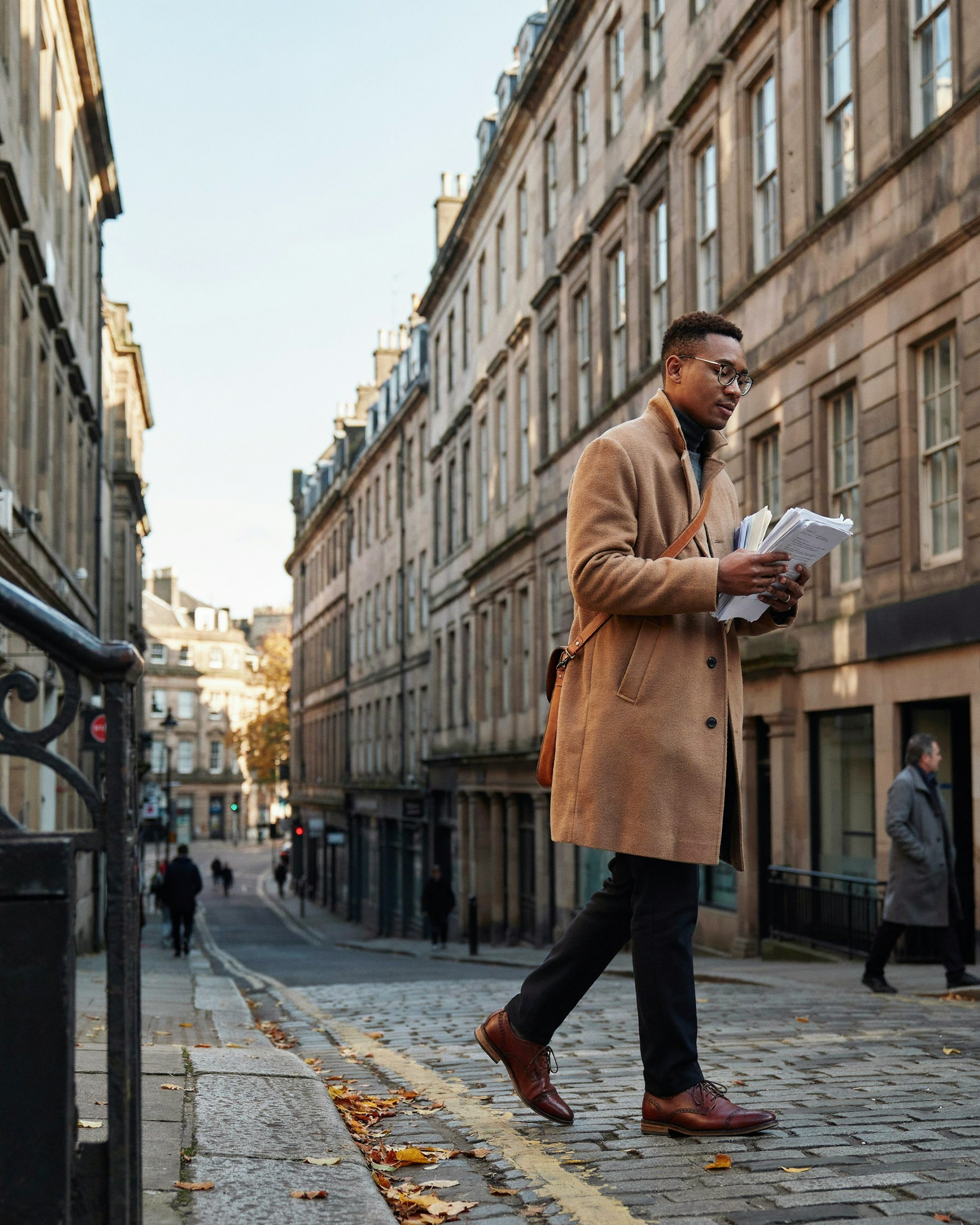 PhD student walking along Chambers Street in Edinburgh on the way to teach