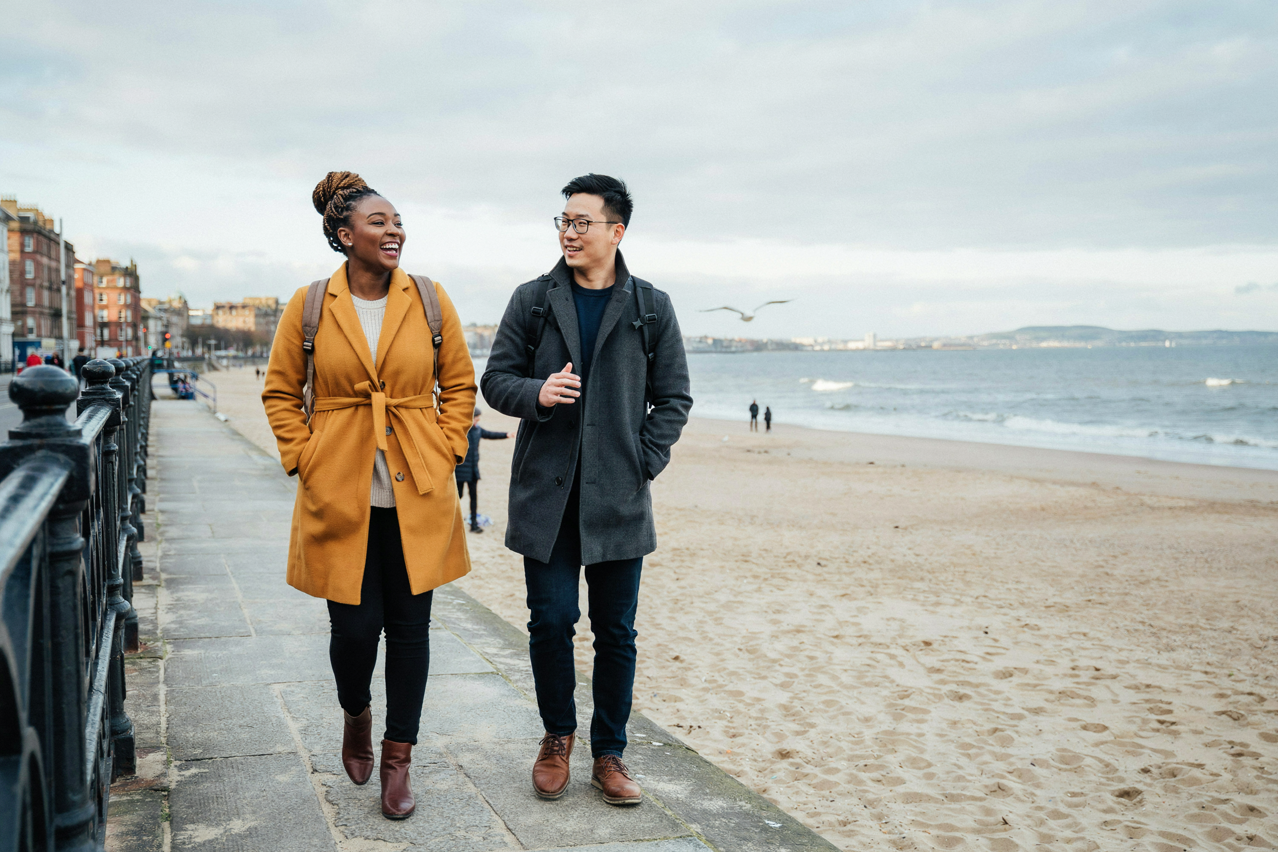 Two students walking along Portobello promenade in Edinburgh in winter