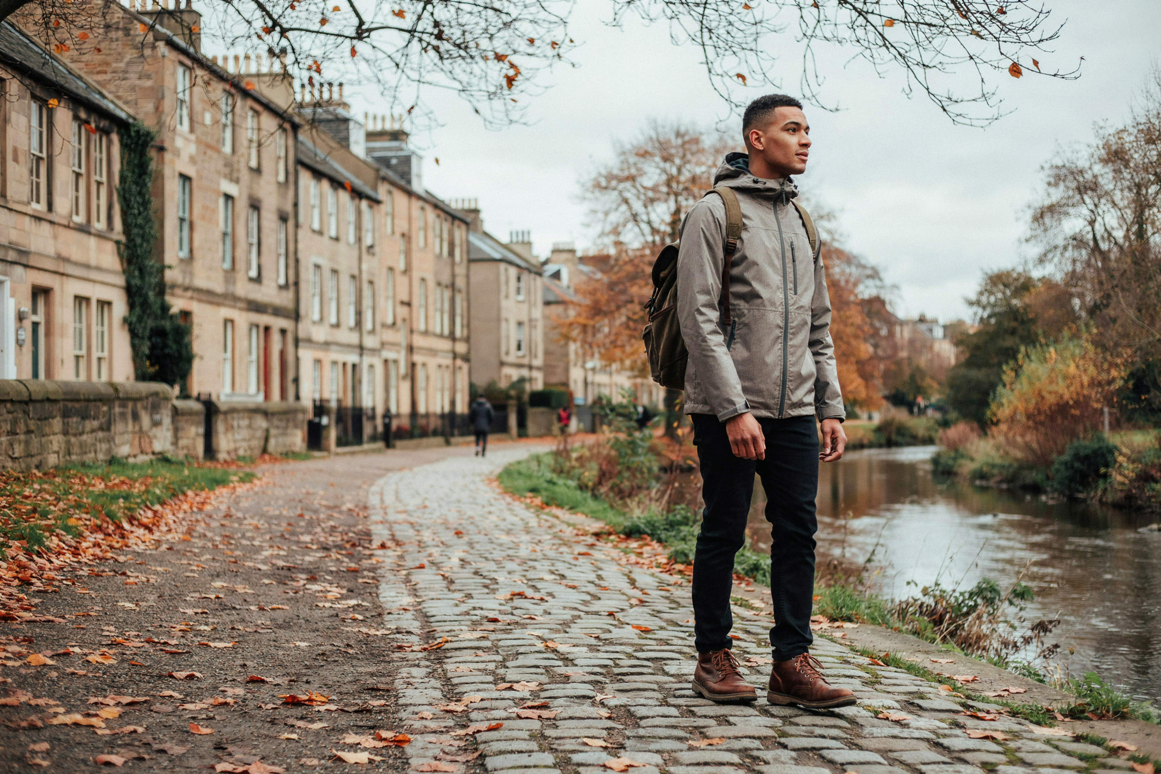 Student walking beside the Water of Leith in Dean Village, Edinburgh