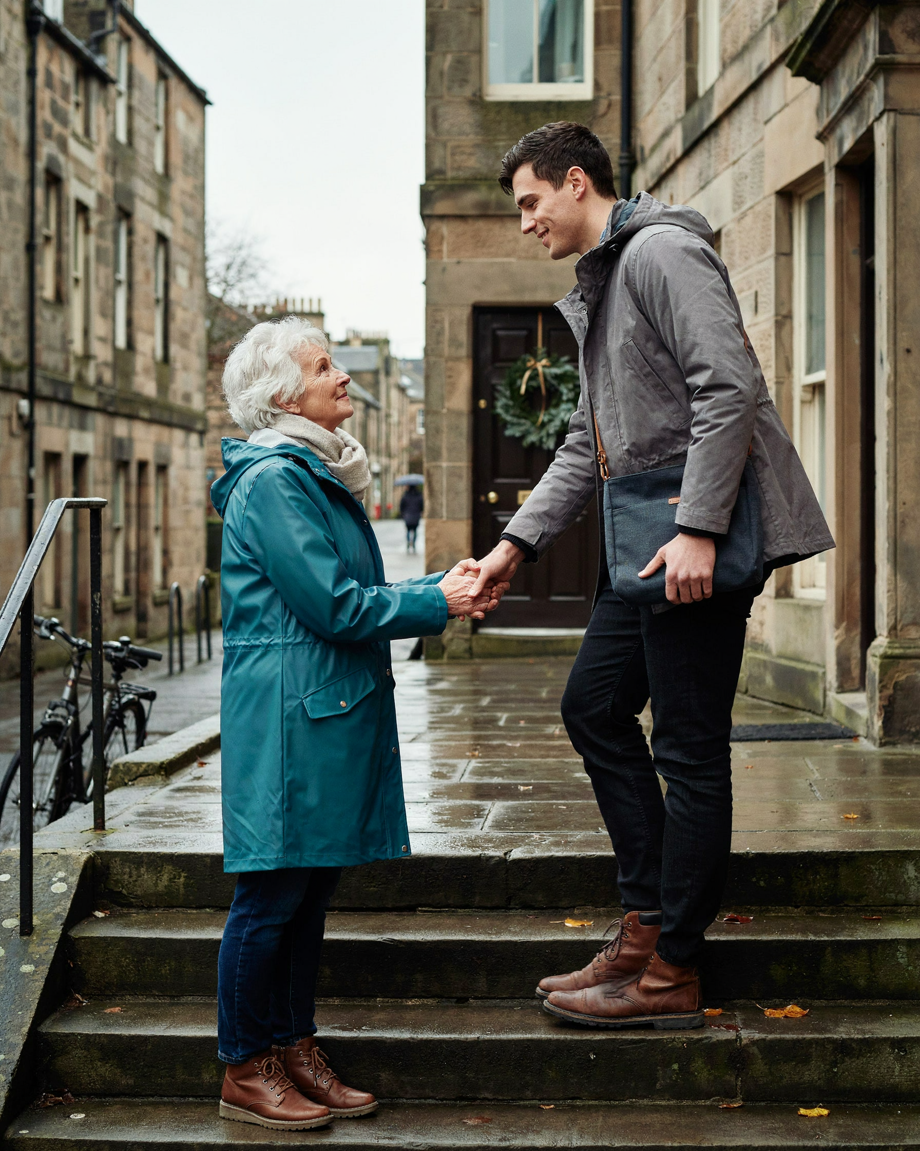Grandson arriving to visit his grandmother at her Stockbridge tenement in Edinburgh in December