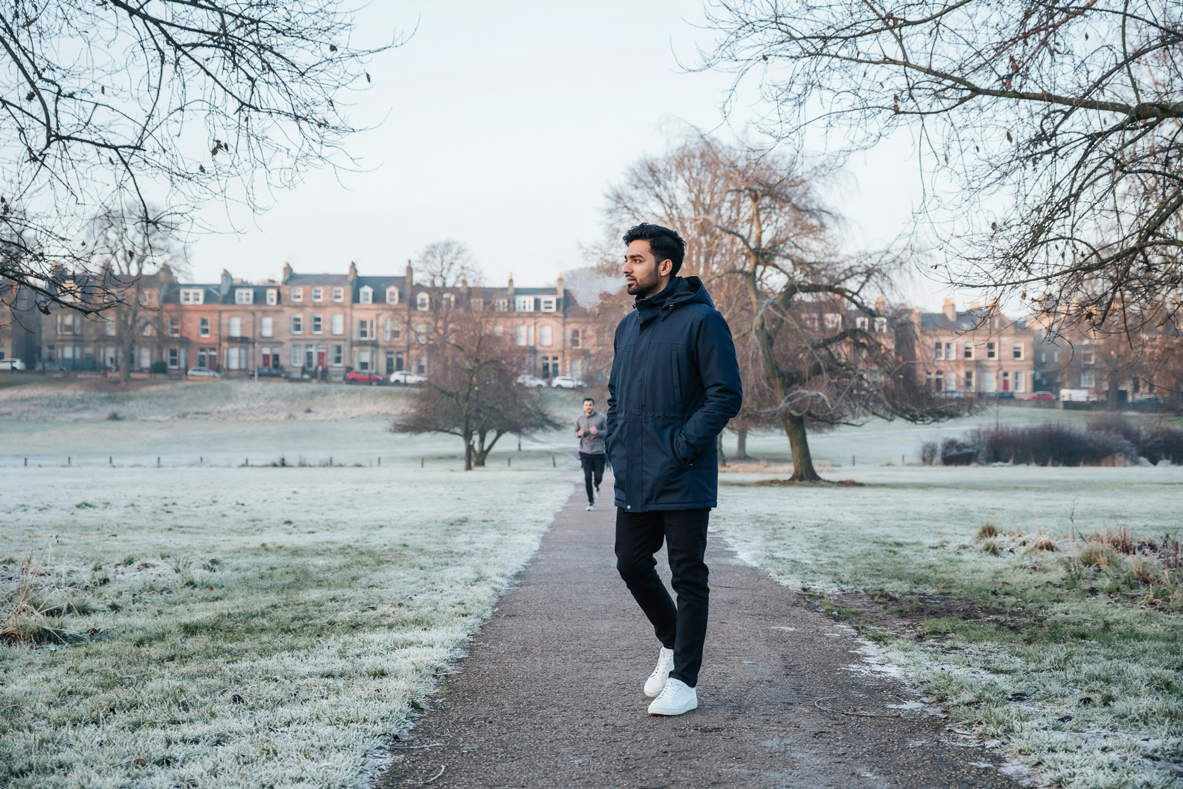 Student crossing the Meadows in Edinburgh on a frosty morning