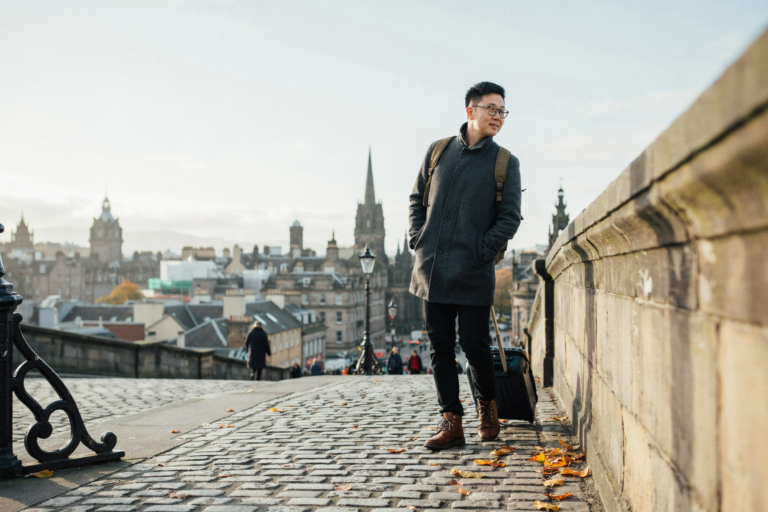 International student with a suitcase on North Bridge in Edinburgh