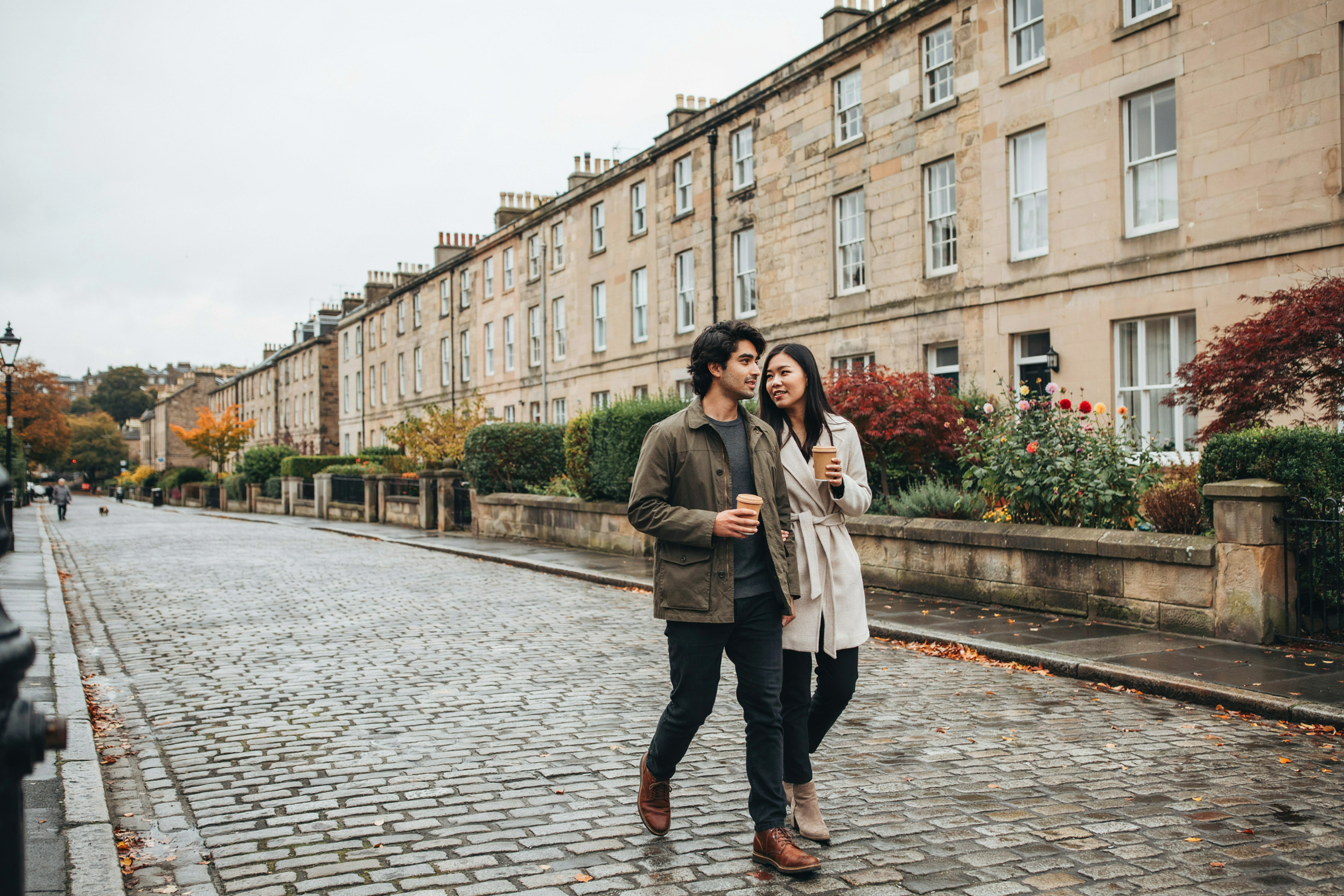 Two friends walking through the Stockbridge Colonies in Edinburgh on an autumn afternoon
