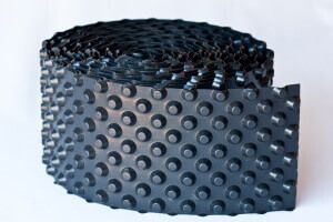 photo of a roll of dimple board waterproofing plastic membrane used to waterproof basements