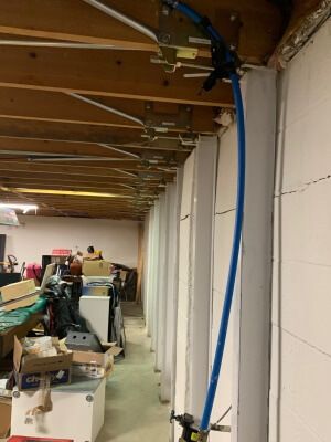 White cement basement block wall with the Gorilla Wall Braces bracing system installed