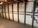 The same braced basement wall seen from the opposite end, with even brace spacing along the run
