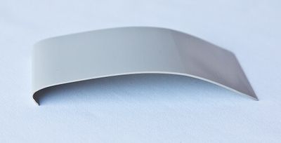 grey vinyl joint connector - a flat piece of grey waterproofing vinyl baseboard with a slight curve