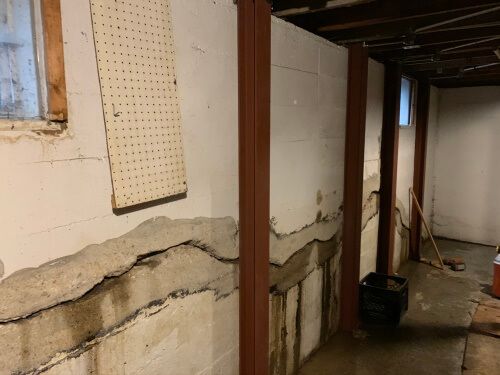 Photo of a severely bowed basement wall fixed with Gorilla Wall Braces