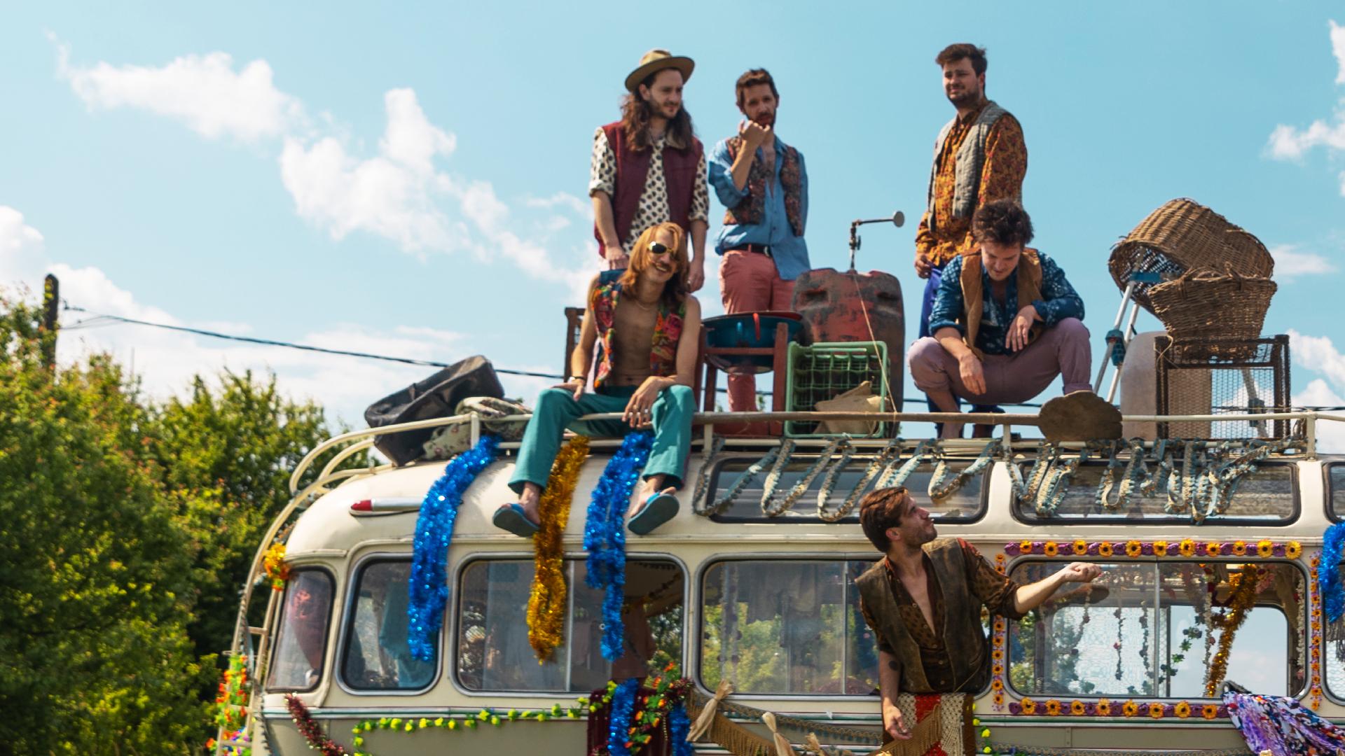 members of Bohemian Betyars are sitting on a top of a Bus
