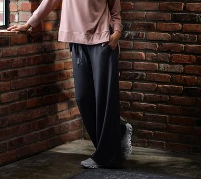 Women wearing the luxuriously soft Essential Tunic in petal & Wide-Leg Pant in charcoal