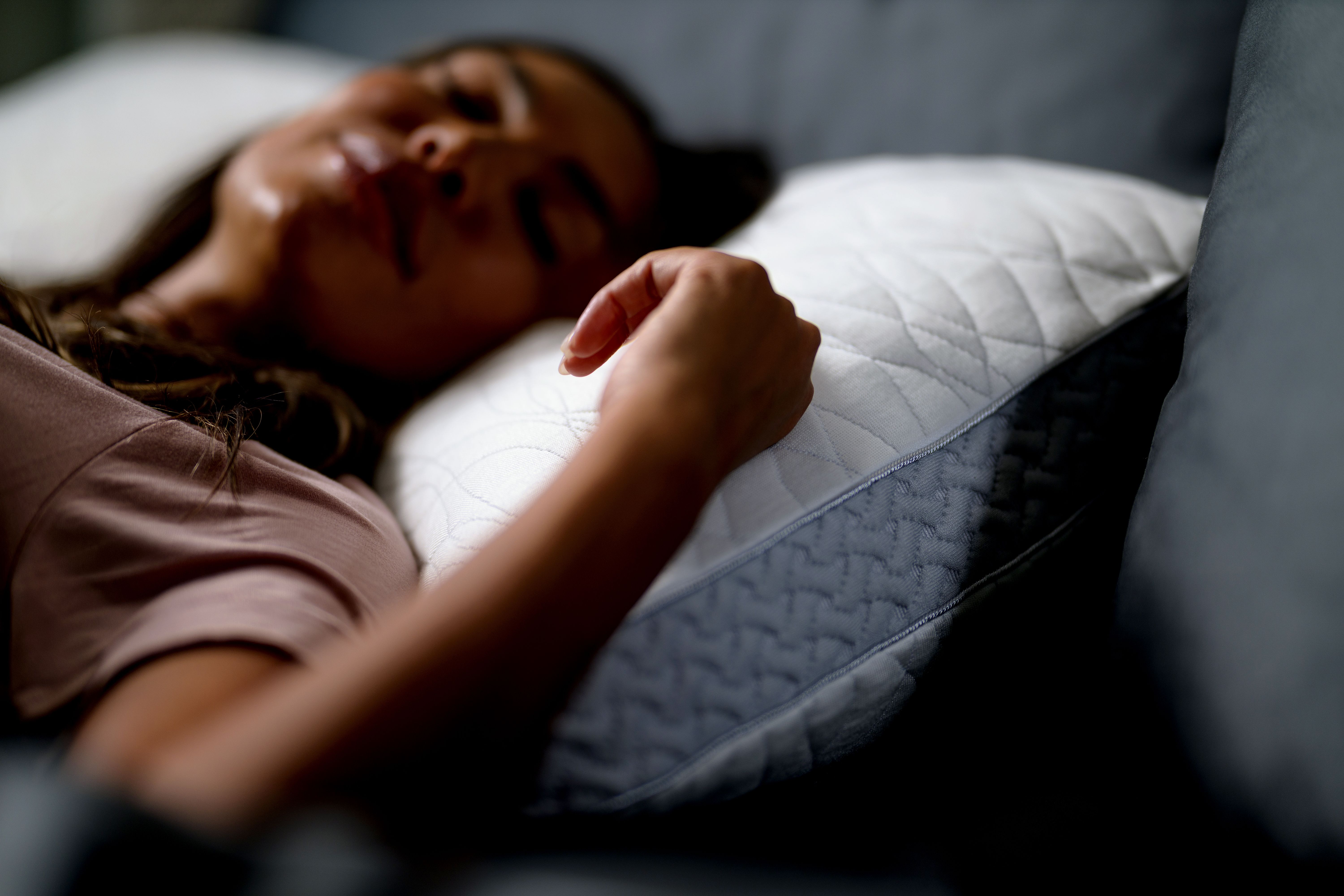 Woman sleeping peacefully on Dual Chamber Pillow