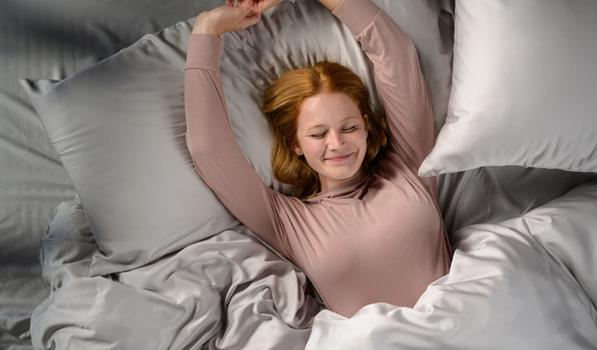 Woman staying cool in Modal Pajamas in peony