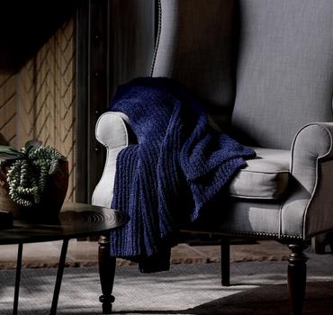 Midnight Ultra Plush Throw on a chair