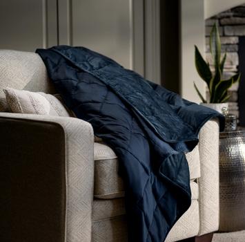 Navy weighted blanket on accent chair