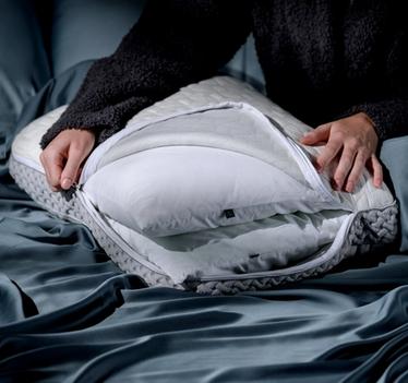 Woman customizing her pillow for the perfect rest