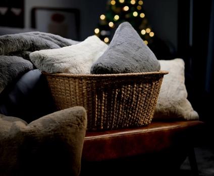 Basket full of luxuriously soft faux fur pillows & blankets