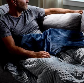 Cuddling under the cozy minky weighted blanket in navy grey dot