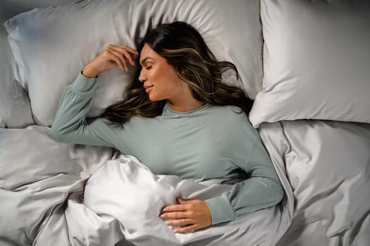 Woman staying cool in Modal Pajamas in mist