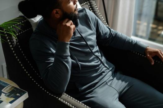 Man wearing the cozy Essential Hoodie in spruce