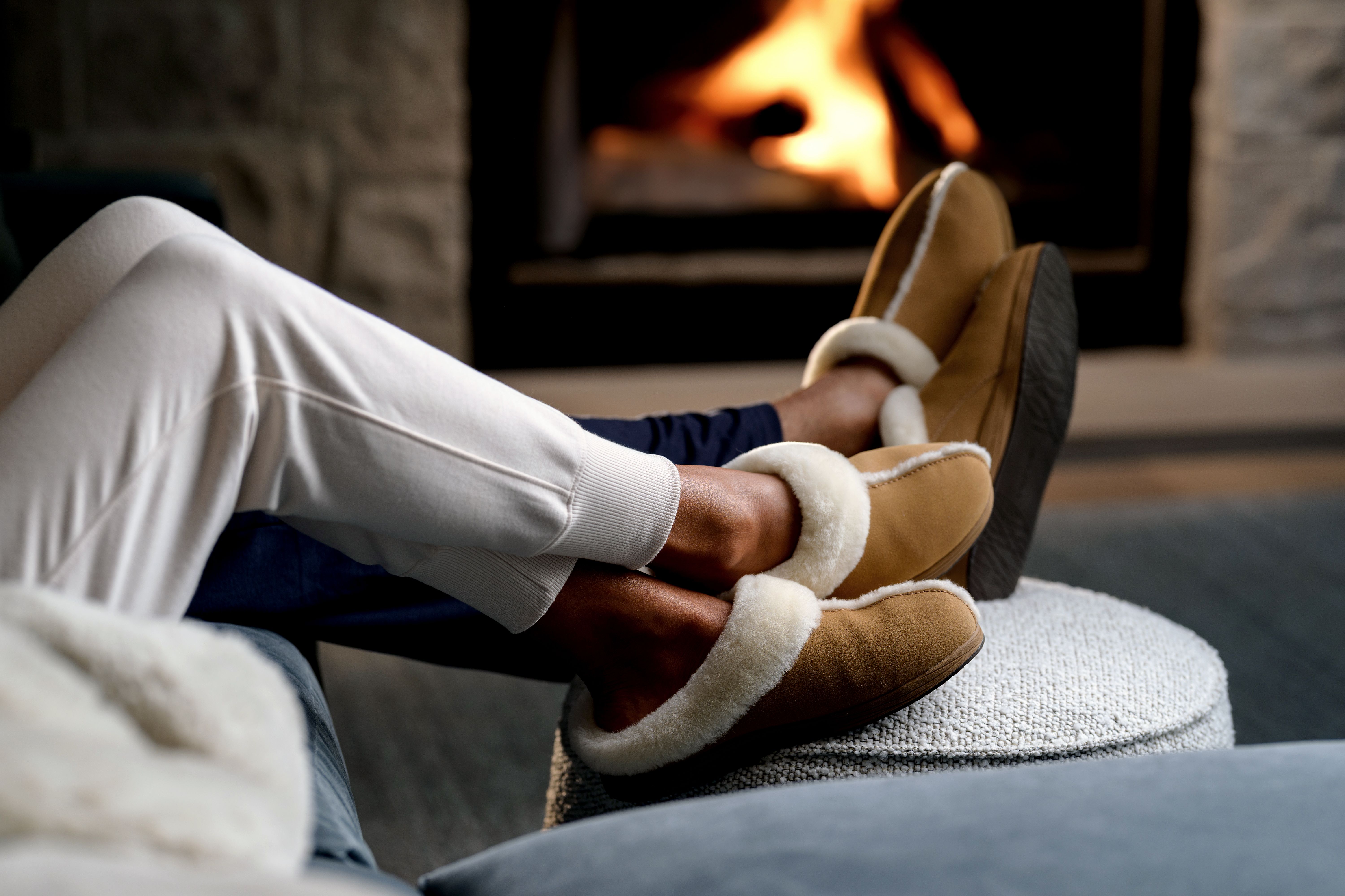 Woman and Man lounging wearing Chestnut Signature Slippers and jogger