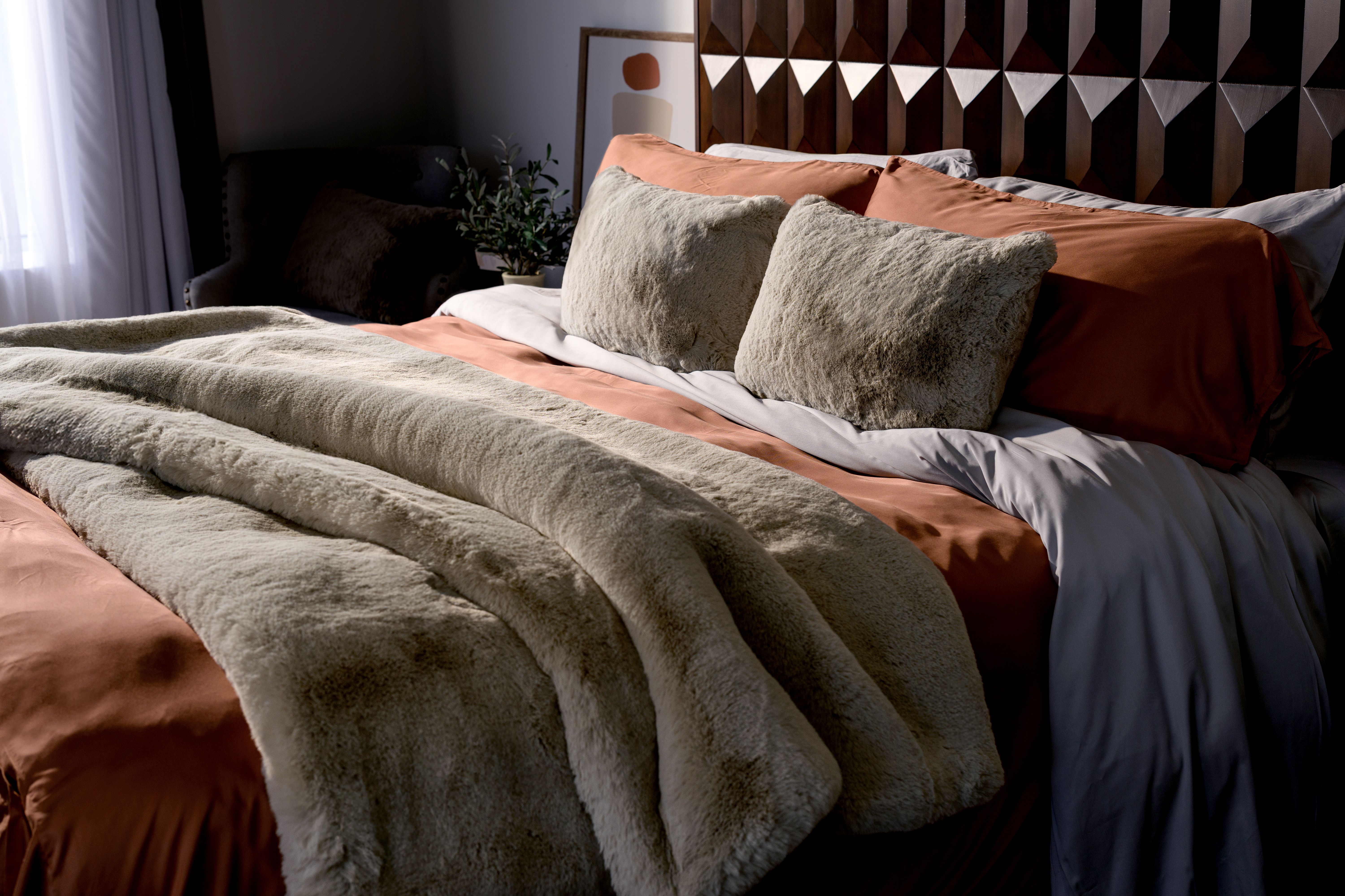 A bed made up of luxurious bedding essentials