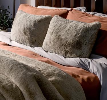 A bed made up of luxurious bedding essentials