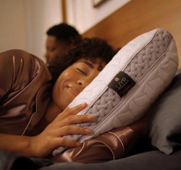 Woman sleeping with LAYR Pillow in bed
