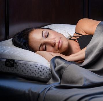 Woman Sleeping on LAYR Pillow in Charcoal Bamboo Sheets