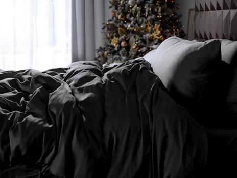 Charcoal bamboo duvet cover on a bed with a christmas tree in the background
