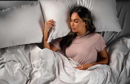 Woman staying cool in Modal Pajamas in peony