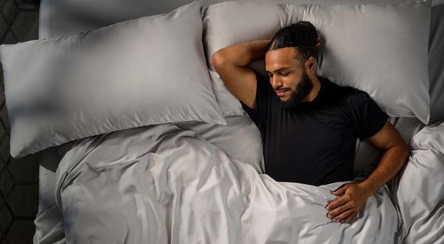 Man sleeping cool with Modal Pajamas in onyx