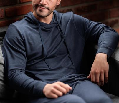 Man wearing the cozy Essential Hoodie in storm