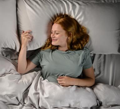 Woman staying cool in Modal Pajamas in mist