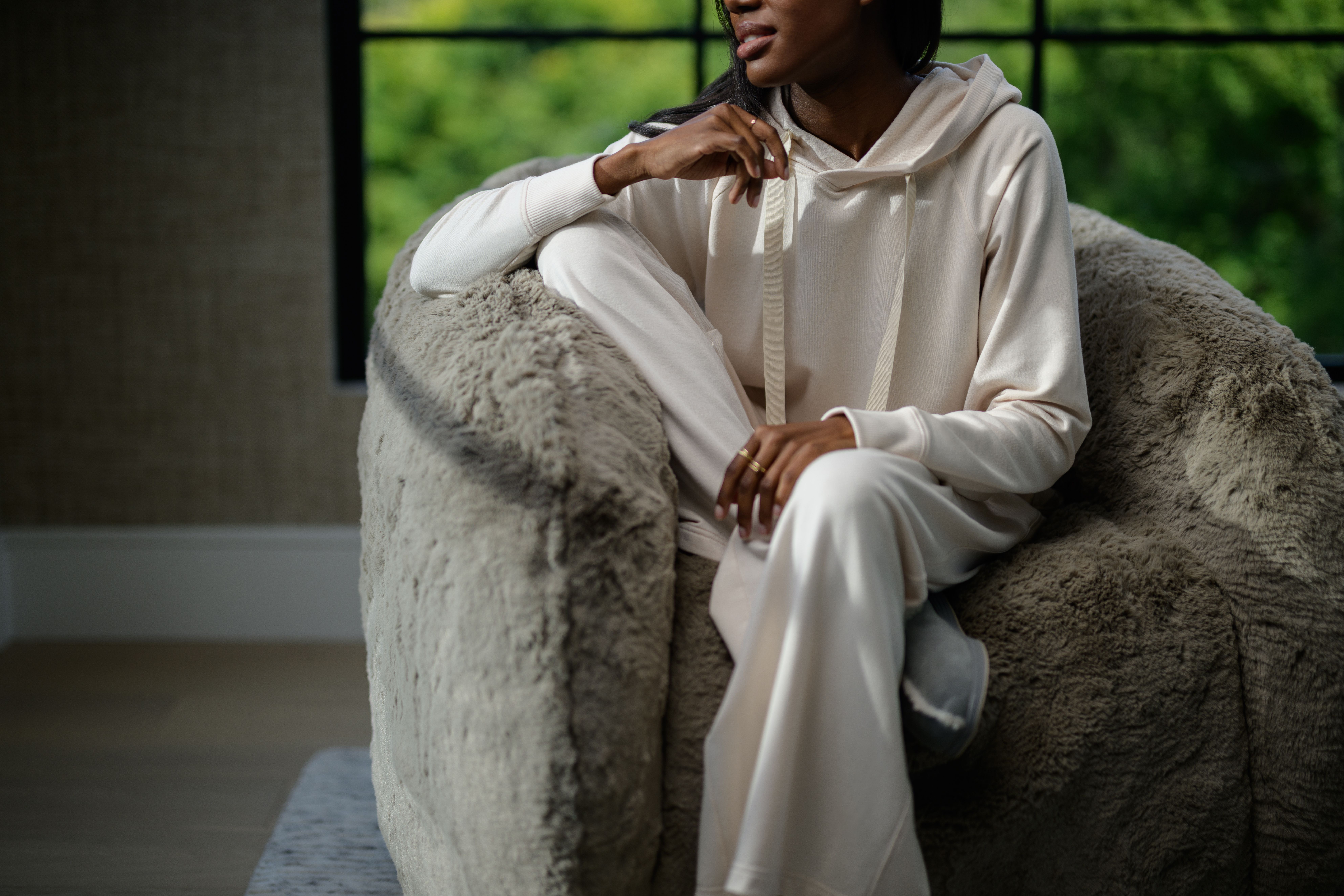 Woman wearing cozy loungewear in the color almond