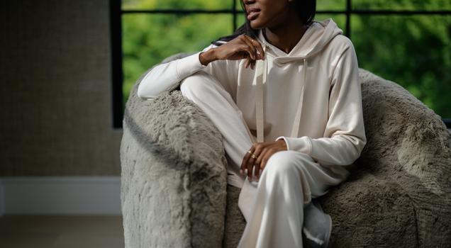 Woman wearing cozy loungewear in the color almond