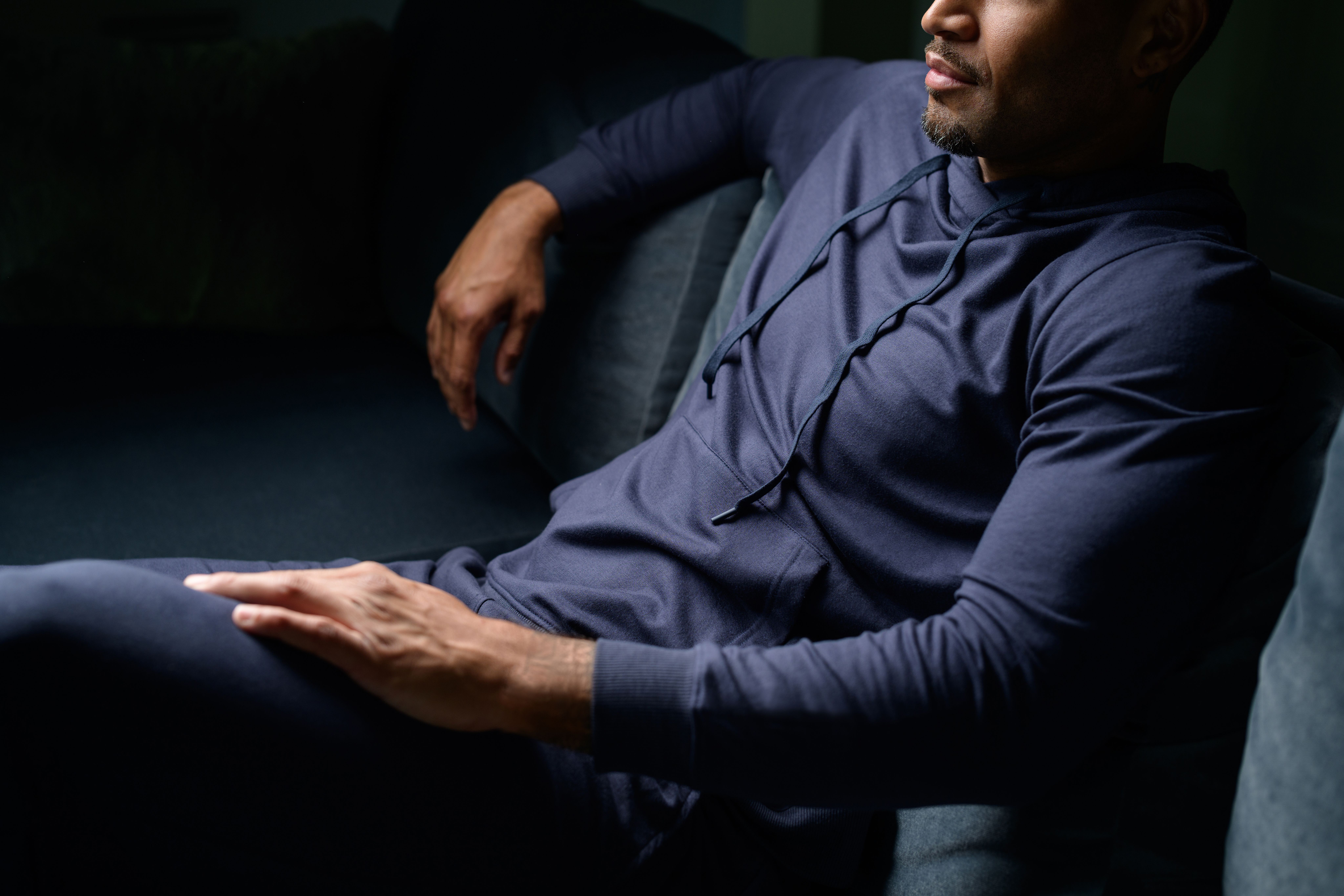 Men wearing the very cozy essential hoodie in storm