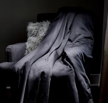 Grey weighted blanket on accent chair