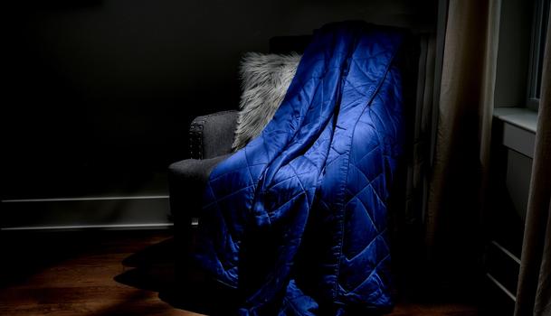 Sapphire Lightweight Blanket sitting on a chair as decor
