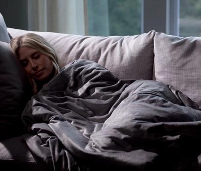 Cuddling under the cozy minky weighted blanket in grey