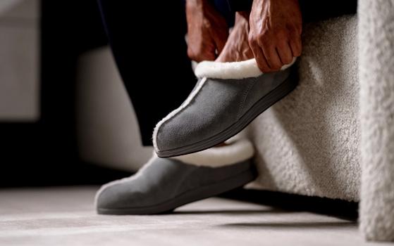 Man slipping on Ash Signature Slipper