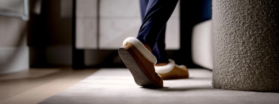 Man walking in bedroom with Chestnut Signature Slippers